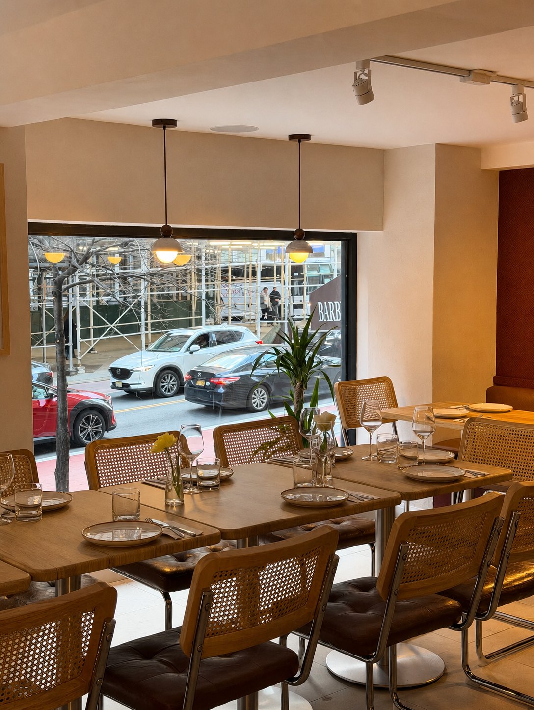 Golden hour light across the window tables at Aromati