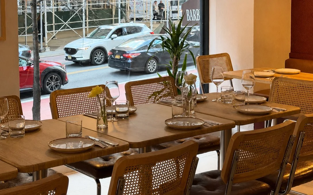 Golden hour light across the window tables at Aromati