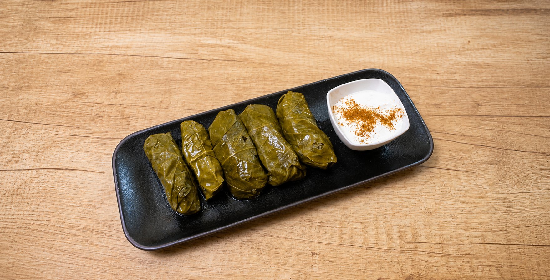 Tolma — grape leaves with garlic sour cream